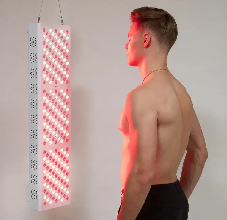 Man using Kala Pro Red Light Therapy Panel for wellness and skin health.