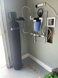 SpringWell Whole House Iron Filter System installed for well water filtration in a home, showcasing advanced filtration technology.