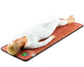 Woman relaxing on Healthyline TAO-Mat® 7224 | PEMF InfraMat Pro, using infrared and PEMF therapy for wellness.