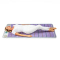 Woman relaxing on Healthyline Platinum Mat™ Pro PLUS 7428, featuring advanced PEMF technology for enhanced wellness and relaxation.