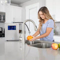 Woman using the Echo Ultimate Hydrogen Water Machine in kitchen for enriched water benefits