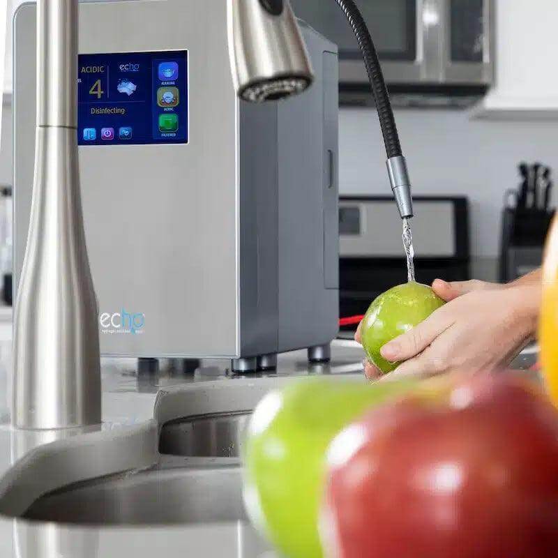 Echo Ultimate Hydrogen Water Machine in kitchen, producing hydrogen enriched water while washing fruit.