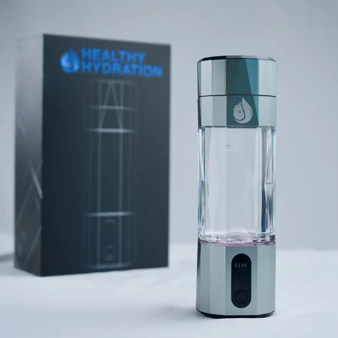 Premium Hydra-Shot Hydrogen Water Bottle by Healthy Hydration displayed with packaging in background.