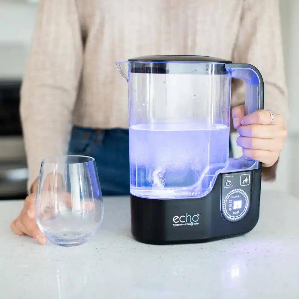 Echo Hydrogen Water Pitcher on countertop with glowing blue light, enhancing hydrogen water for better hydration and antioxidant support.