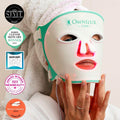 Woman using Omnilux Clear red light therapy mask with award badges, a top-rated LED mask for acne care in Canada.