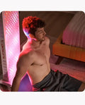 Man using Platinum LED Biomax 900 for full body red light therapy session.