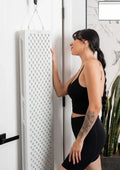 Woman interacting with MitoPRO 1500X full body red light therapy panel, showcasing advanced light therapy technology.